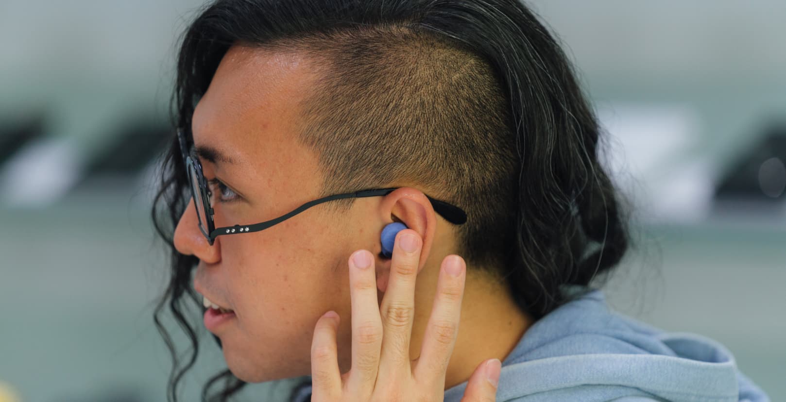 A male with sunglasses talking and smiling.