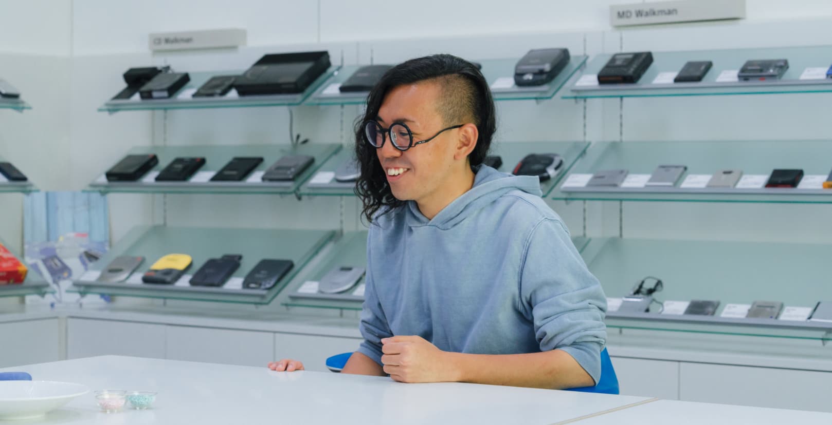 A female on a wheelchair opening a door.