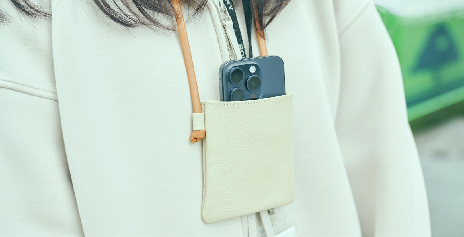 Haruko Miki is wearing neck pouch in which a smartphone is inside