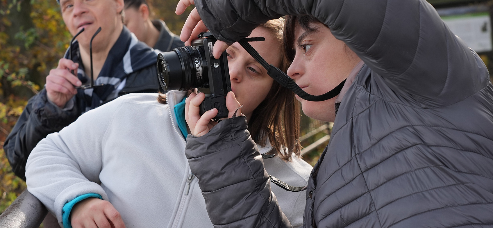 Image showing a young man and young woman inspecting a camera and its LCD monitor screen