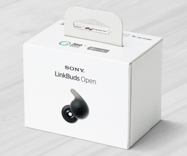 Sony LinkBuds Open packaging. The small white box has black text and an image of the earbud on the front. There is a small handle on the top of the box.
