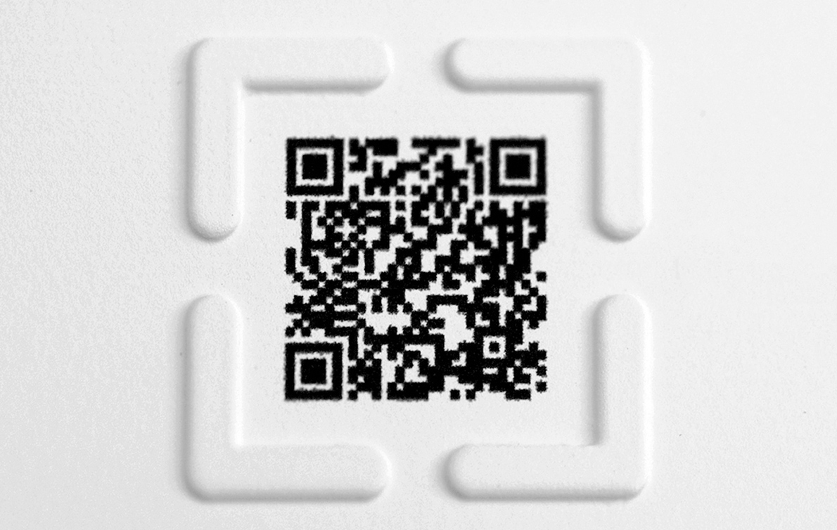 The QR code is framed by raised L-shaped corners