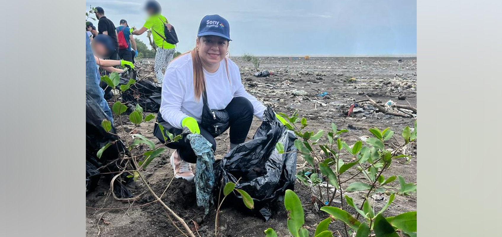 Photo of people picking up trash on the beach